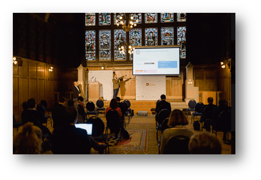speaker presenting in front of an audience