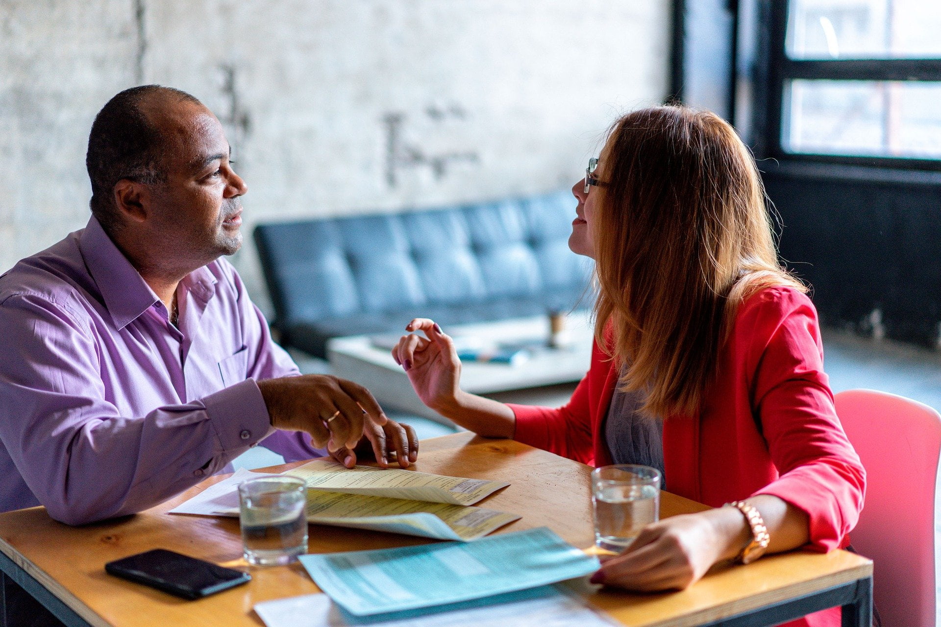 two people talking around a table